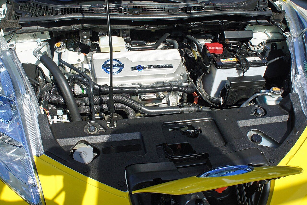 Electric car motor bay with control unit on the left and a small twelve-volt battery on the right