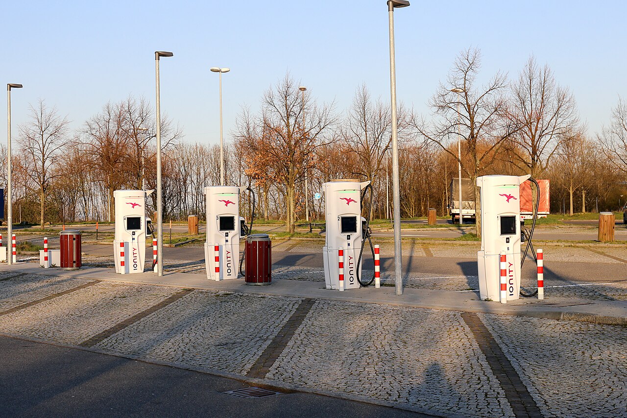 Rapid charging bays with marked parking spaces beside a motorway services building