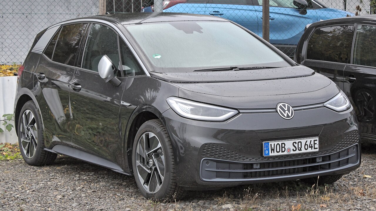 Electric hatchback photographed from the front three-quarter angle on a street