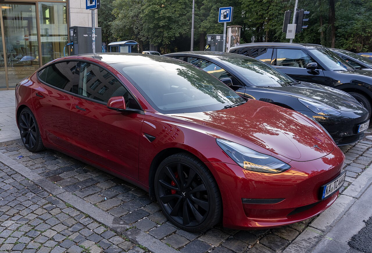 Electric saloon car parked at the roadside in Munich