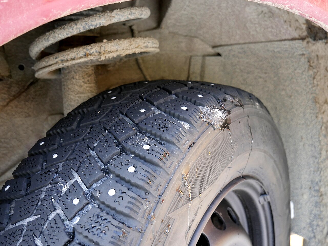 Tread pattern of a studded winter tyre photographed close up